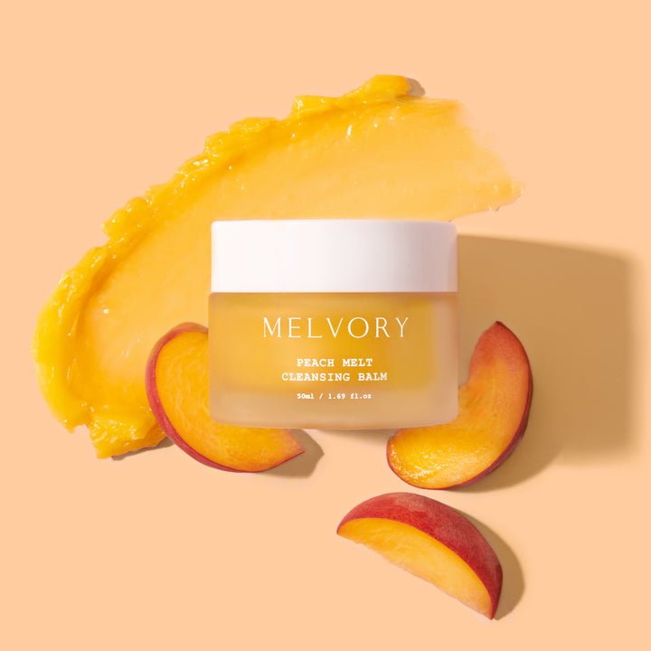 Melvory peach melt cleansing balm with peach slices on a peach background
